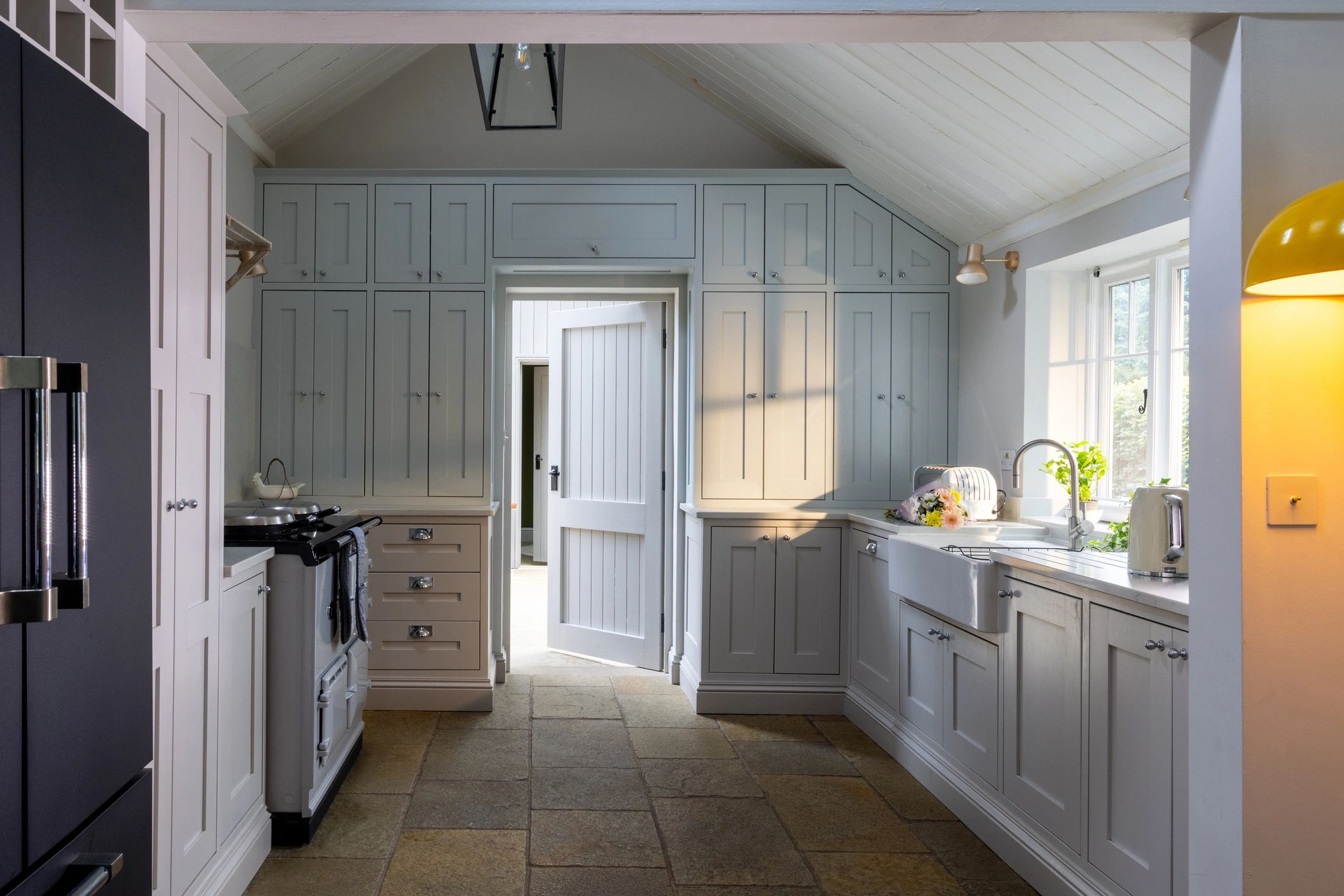 Sunlit kitchen with abundant cabinetry