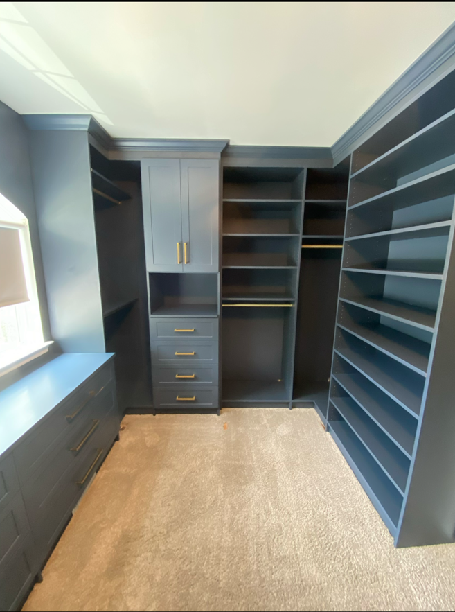 Custom walk-in closet cabinetry with shelving, drawers, and hanging storage
